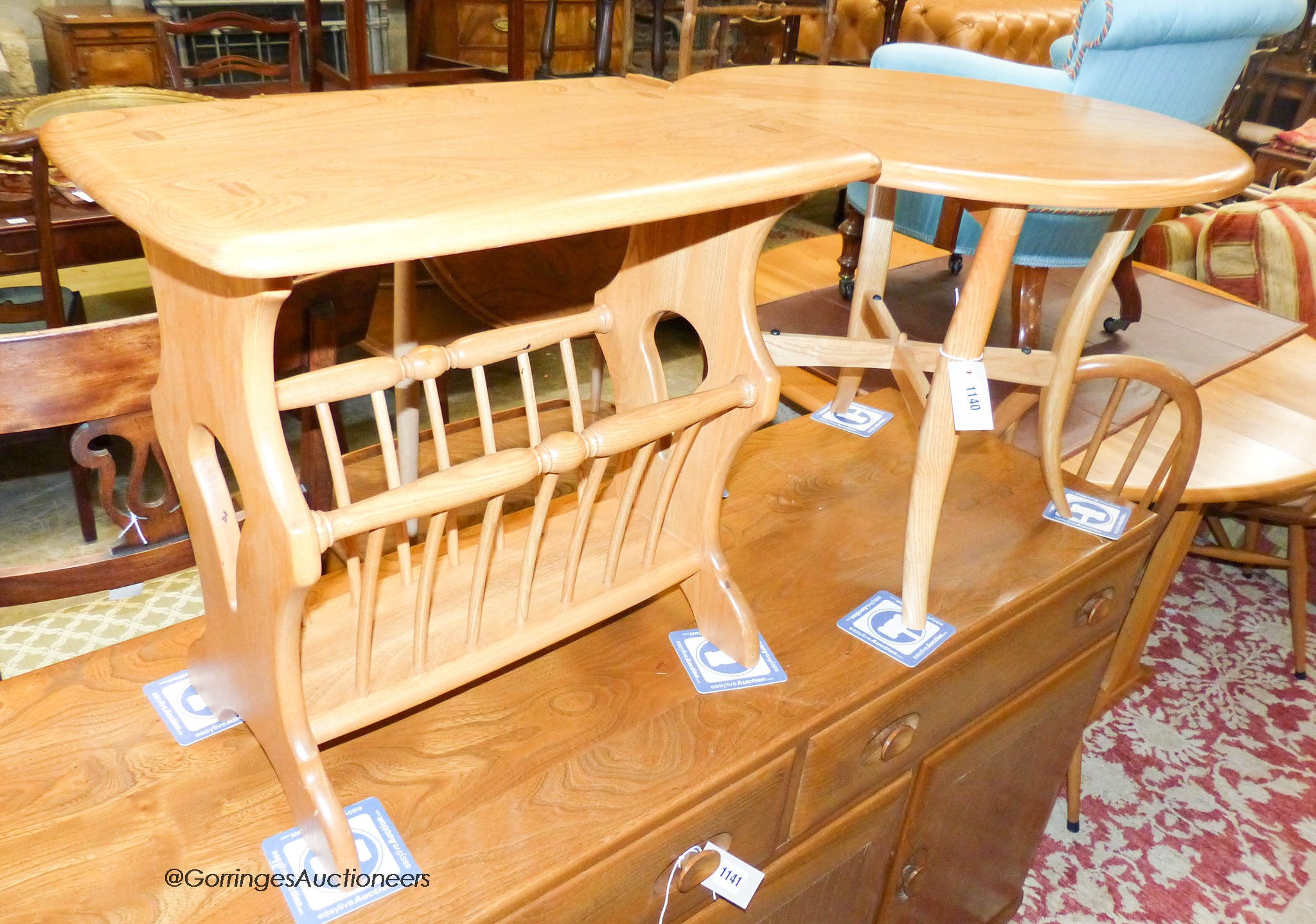 An Ercol elm circular occasional table, 60cm diameter, height 48cm together with an Ercol elm magazine table